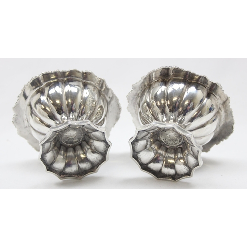 1001 - A pair of George IV period heavy gauge silver salts with gilt interior and floral border, armorial c... 