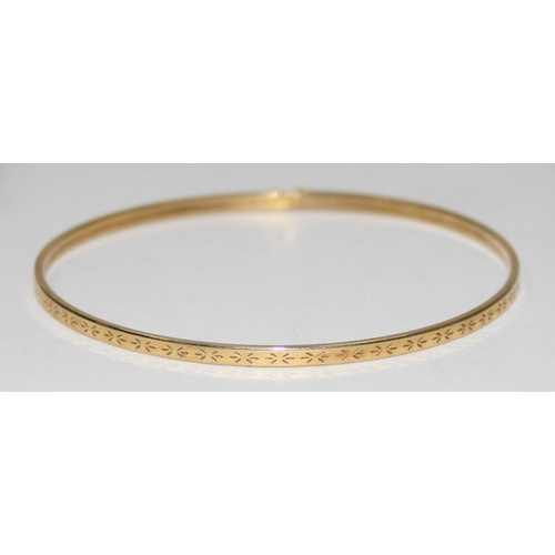 2012 - A 9ct gold bangle with engraved decorations, marked 9kt and XRF confirmed, approx 65mm in diameter, ... 