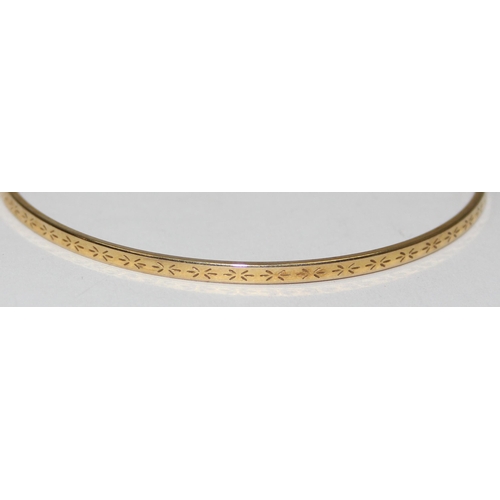 2012 - A 9ct gold bangle with engraved decorations, marked 9kt and XRF confirmed, approx 65mm in diameter, ... 