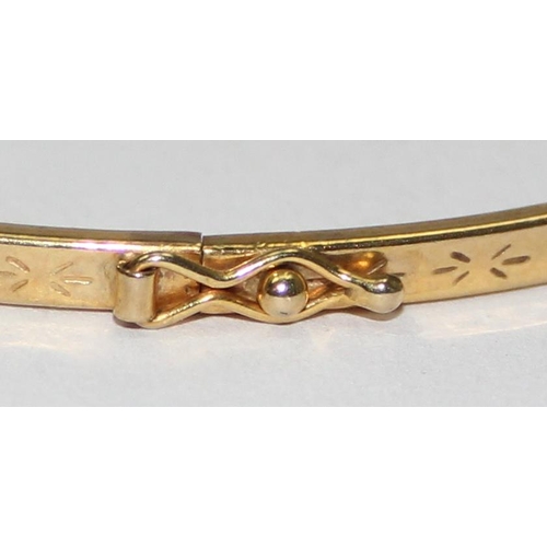 2012 - A 9ct gold bangle with engraved decorations, marked 9kt and XRF confirmed, approx 65mm in diameter, ... 