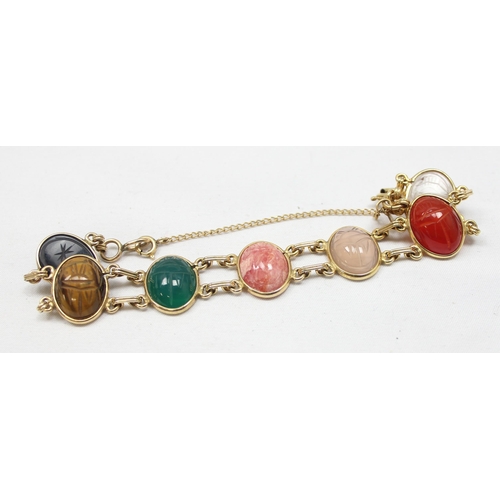 2030 - A good quality gold filled and cabochon stone bracelet, each of the 7 stones with carved details