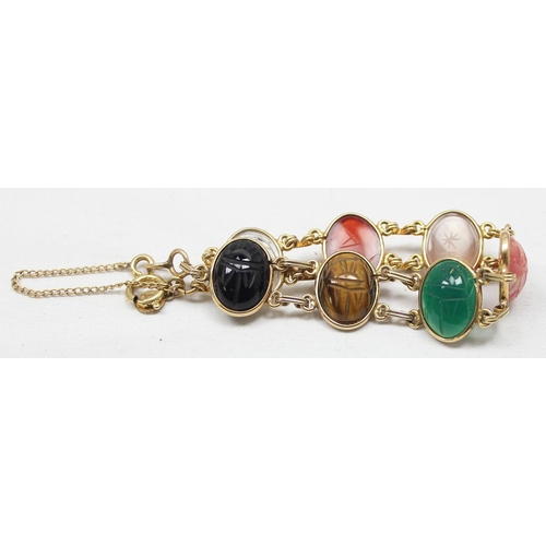 2030 - A good quality gold filled and cabochon stone bracelet, each of the 7 stones with carved details