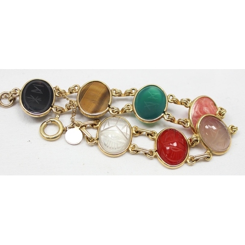 2030 - A good quality gold filled and cabochon stone bracelet, each of the 7 stones with carved details