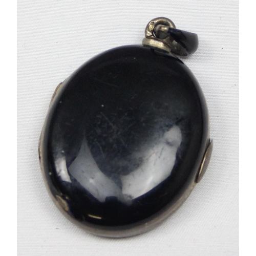 2033 - A Victorian black enamel and seed pearl on silver mourning locket, indistinctly marked to loop but X... 