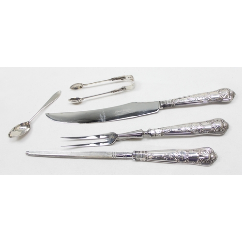 1015 - A pair of Victorian silver Apostle sugar tongs, London 1883, a silver tea spoon and a silver handled... 