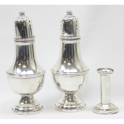 1038 - A pair of American weighted silver pepper pots and a weighted Sterling silver miniature candlestick ... 