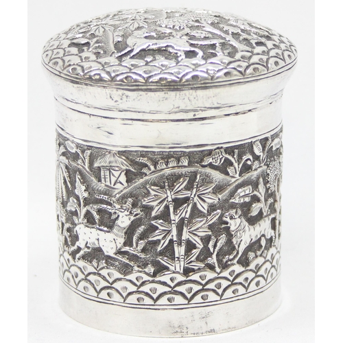 1040 - An Indian silver lidded pot with embossed decoration of animals in a jungle setting, unmarked but XR... 