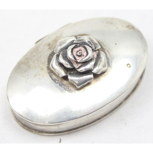 1049 - A small 925 silver pill box with rose finial, marked to base with import marks for Sheffield 1997, a... 