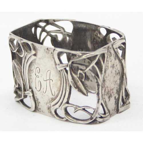 1051 - An Art Nouveau influenced Scottish silver napkin ring, having pierced sinuous decoration, Edinburgh ... 