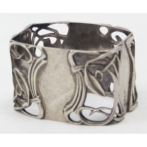 1051 - An Art Nouveau influenced Scottish silver napkin ring, having pierced sinuous decoration, Edinburgh ... 