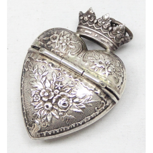 1075 - A Scandinavian silver Hovedvandsæg (heart shaped spice box) of heart form with embossed floral decor... 