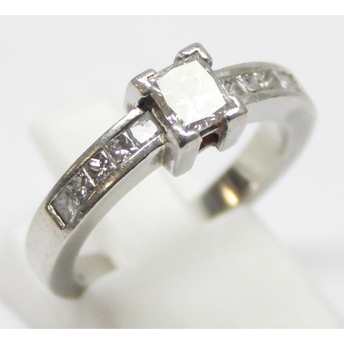 2293 - A Platinum ring set with a large central square Princess cut diamond and flanked with 5 similar squa... 