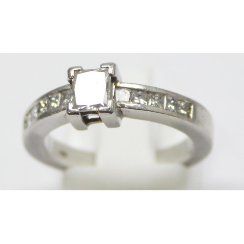 2293 - A Platinum ring set with a large central square Princess cut diamond and flanked with 5 similar squa... 