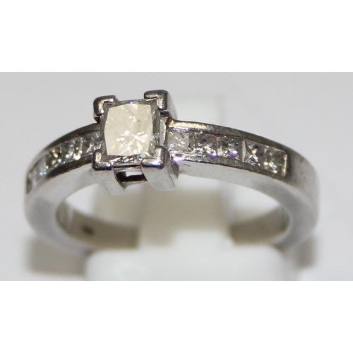 2293 - A Platinum ring set with a large central square Princess cut diamond and flanked with 5 similar squa... 