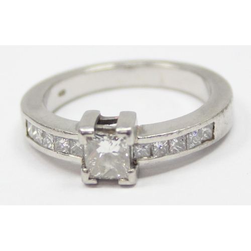 2293 - A Platinum ring set with a large central square Princess cut diamond and flanked with 5 similar squa... 