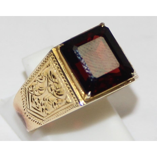 2304 - A large decorative 14ct gold ring set with square cut red stone, seemingly unmarked but XRF tests as... 