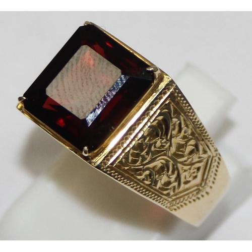 2304 - A large decorative 14ct gold ring set with square cut red stone, seemingly unmarked but XRF tests as... 