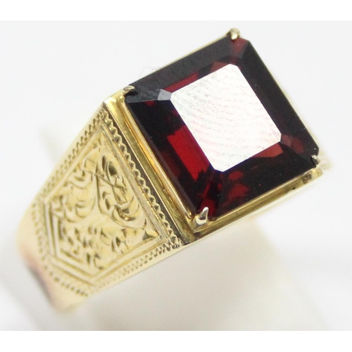 2304 - A large decorative 14ct gold ring set with square cut red stone, seemingly unmarked but XRF tests as... 