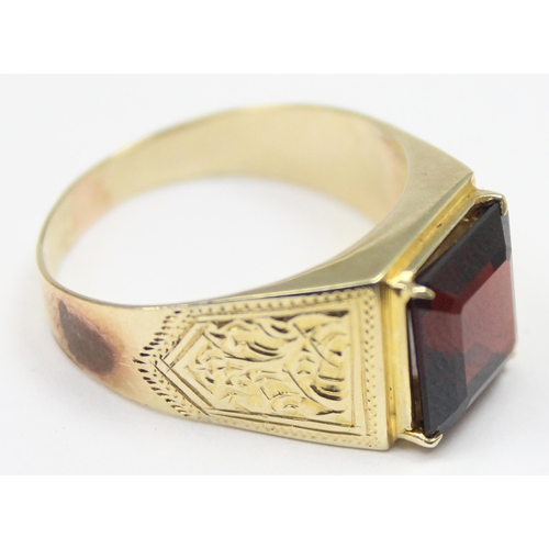 2304 - A large decorative 14ct gold ring set with square cut red stone, seemingly unmarked but XRF tests as... 