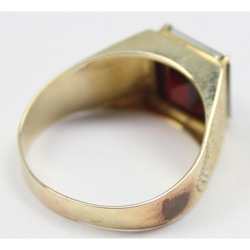 2304 - A large decorative 14ct gold ring set with square cut red stone, seemingly unmarked but XRF tests as... 