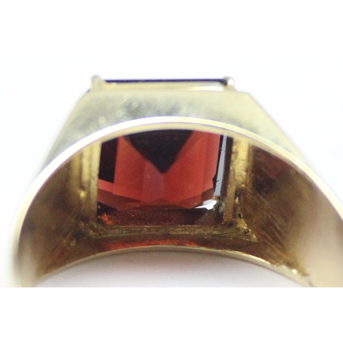 2304 - A large decorative 14ct gold ring set with square cut red stone, seemingly unmarked but XRF tests as... 