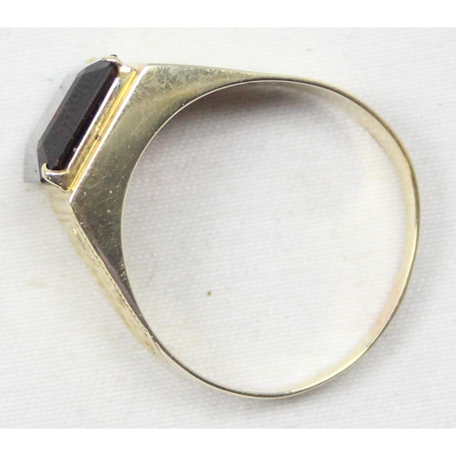 2304 - A large decorative 14ct gold ring set with square cut red stone, seemingly unmarked but XRF tests as... 