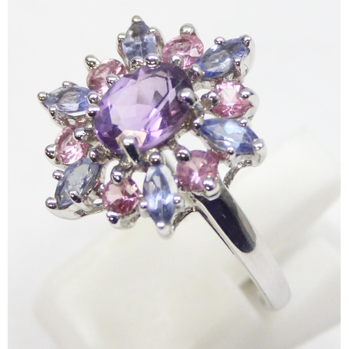 2378 - A 9ct white gold dress ring set with light purple stones in a floral setting, full English hallmarks... 