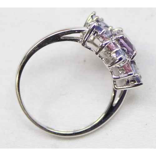 2378 - A 9ct white gold dress ring set with light purple stones in a floral setting, full English hallmarks... 