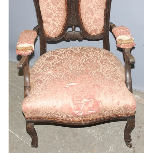 107 - Victorian mahogany low-seated arm chair with pierced decoration on ceramic castors