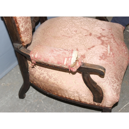 107 - Victorian mahogany low-seated arm chair with pierced decoration on ceramic castors