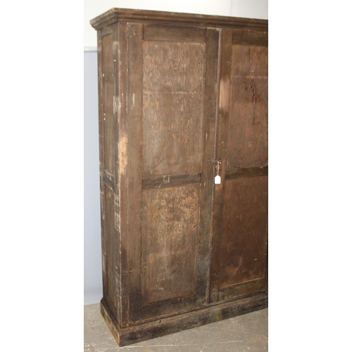 114 - A large antique stained pine hall cupboard made by The Oxford Cabinet Co of Marlborough Rd, Oxford, ... 