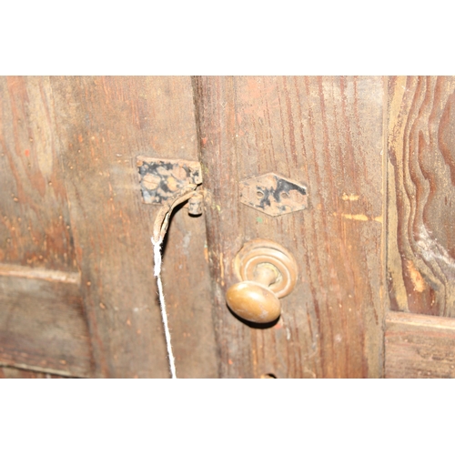 114 - A large antique stained pine hall cupboard made by The Oxford Cabinet Co of Marlborough Rd, Oxford, ... 