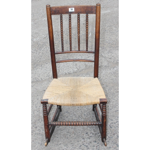 30 - In the manner of Liberty, an early 20th century child's bobbin turned rocking chair with rush seat, ... 