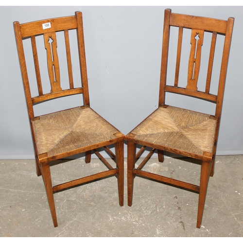 100 - 2 Arts & Crafts period light oak and rush-seated chairs