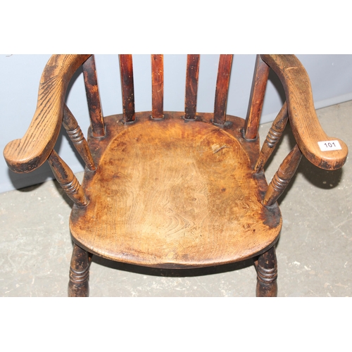 101 - An early 20th century elm seated farmhouse high back Windsor chair, approx 106cm tall