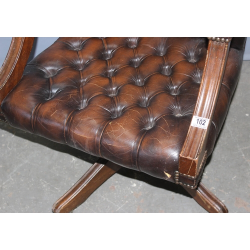 102 - A brown leather button backed and seated captain's or office swivel chair