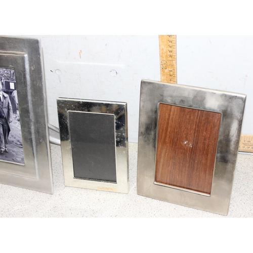 1024 - 4 silver plated free-standing photo frames, largest approx 31cm x 26cm