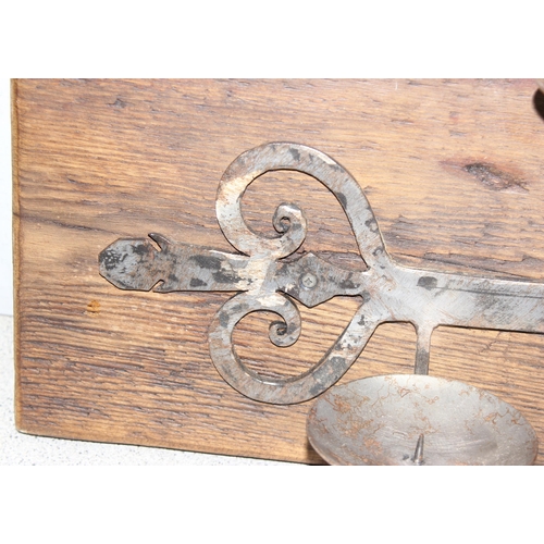 1762 - Hand forged rustic triple metal candle stand mounted on wooden wall mounting board, approx 55cm x  2... 