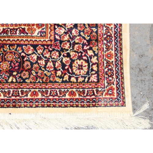 208 - A large red and cream ground Tabriz style rug with Tiznit label, approx 138 cm x 206 cm