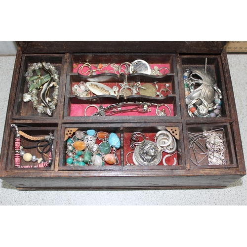 2334 - A vintage wooden jewellery box and contents to inc a number of silver earrings and a silver christen... 