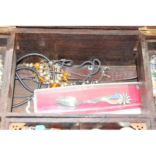 2334 - A vintage wooden jewellery box and contents to inc a number of silver earrings and a silver christen... 