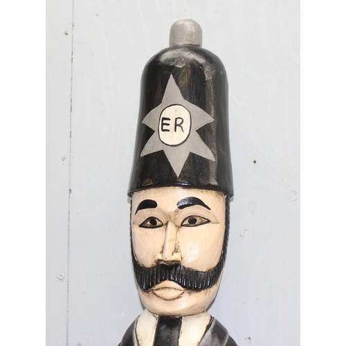 279 - Large tall hand carved and painted novelty standing policeman with radio on wooden plinth base, appr... 