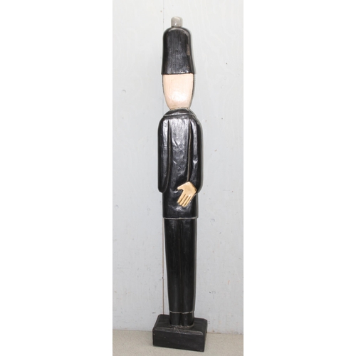 279 - Large tall hand carved and painted novelty standing policeman with radio on wooden plinth base, appr... 