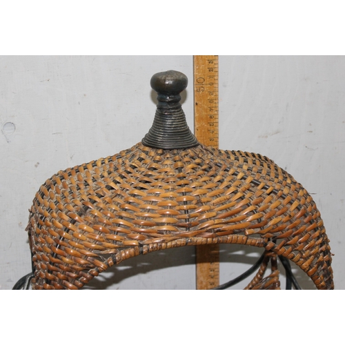 281 - An interesting raised wicker basket on wrought iron stand, approx 55cm tall