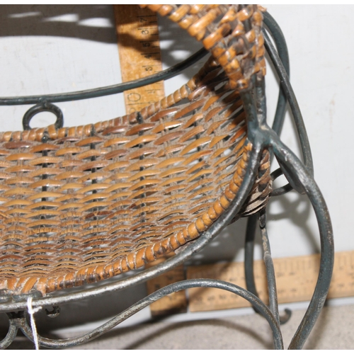 281 - An interesting raised wicker basket on wrought iron stand, approx 55cm tall