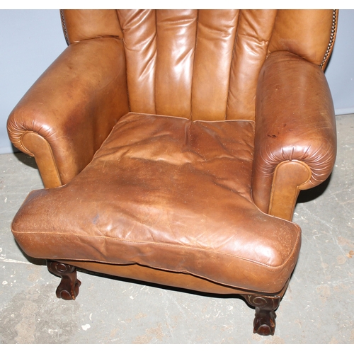 116 - A Georgian style light brown leather or leatherette club chair with ball and claw feet