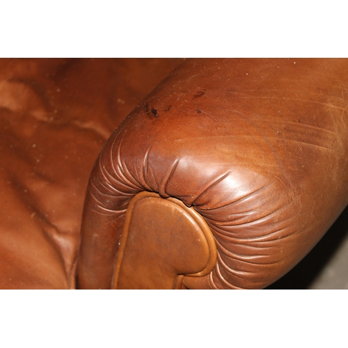 116 - A Georgian style light brown leather or leatherette club chair with ball and claw feet