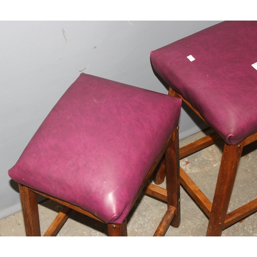 121 - 2 purple upholstered stools with wooden bases, approx 57cm tall