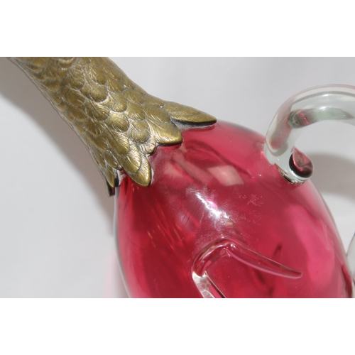 1655 - A rare cranberry glass and silver plate mounted decanter or claret jug formed as a duck, the feet ma... 