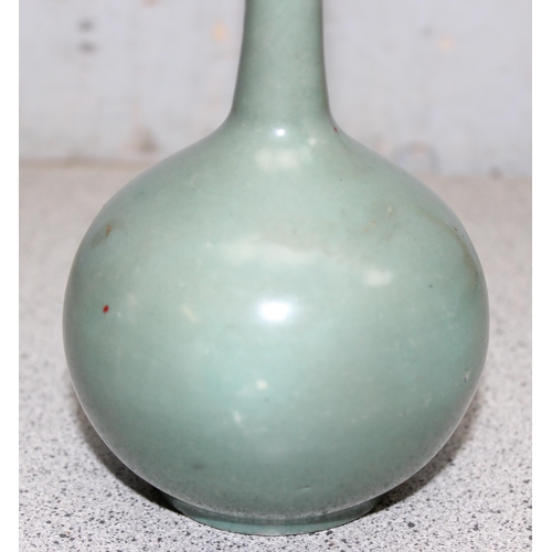 1603 - An antique Chinese or Japanese bottle vase with sage coloured green glaze, various marks to base, ap... 